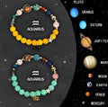 Set of two natural stone beaded bracelets showing different zodiac signs on an elastic cord.