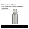 Large stainless steel outdoor thermal pot with a handle, shown in a natural setting.