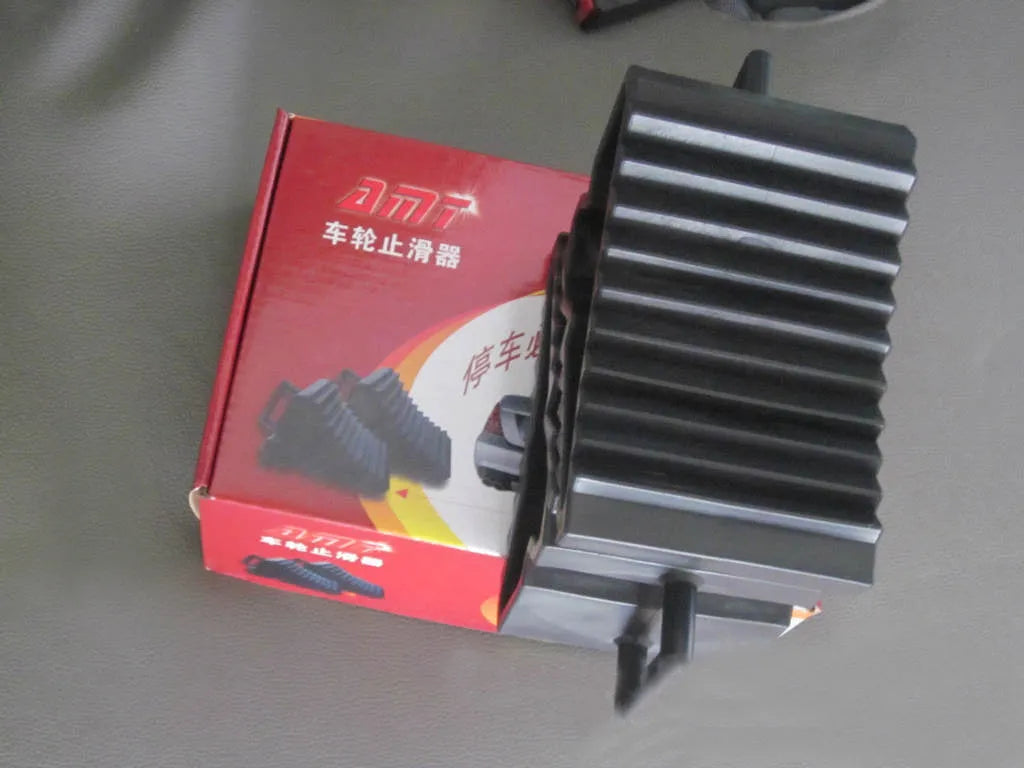 Pair of triangular car wheel stoppers in black colour with storage boxes