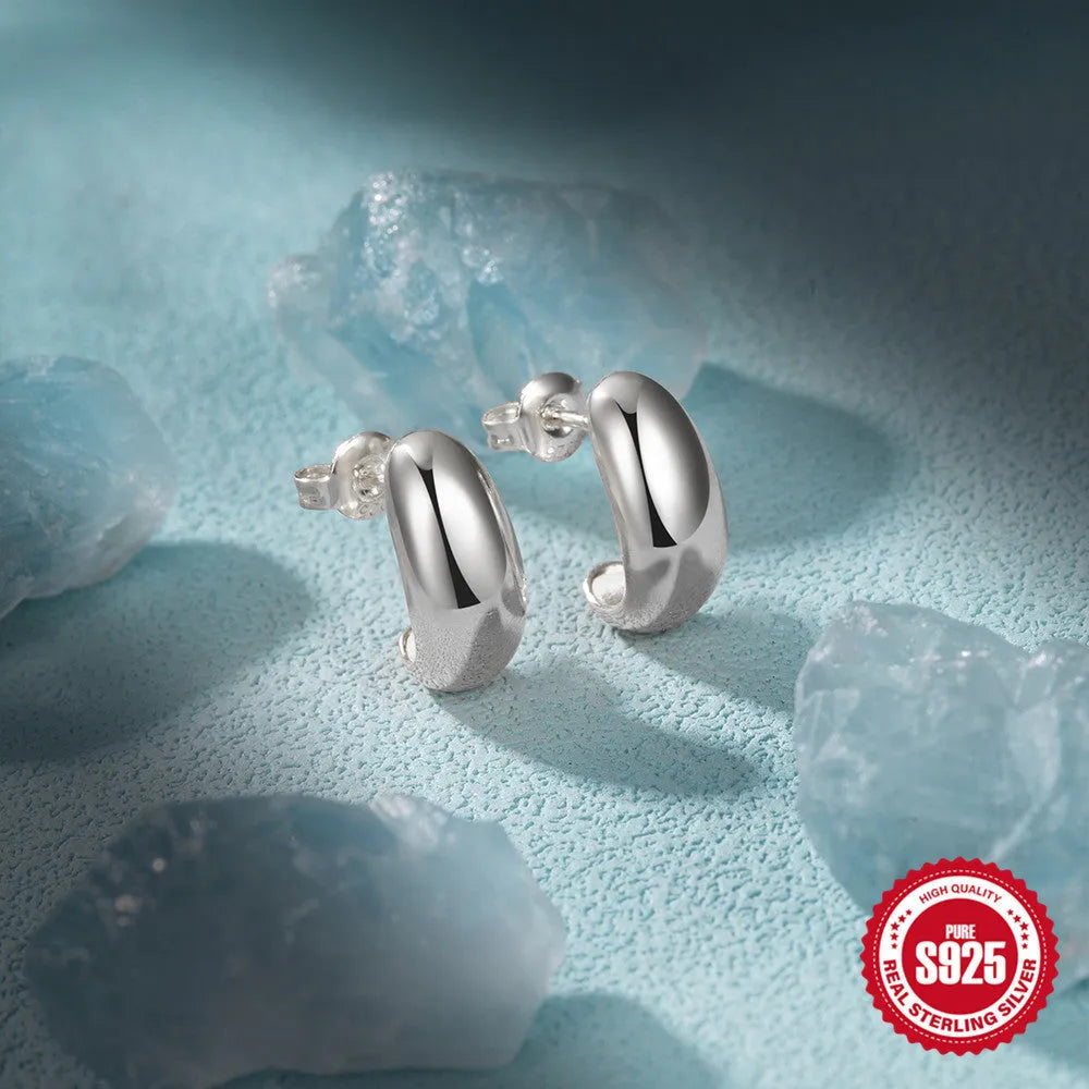 Sterling silver C-shaped stud earrings with glossy electroplated finish