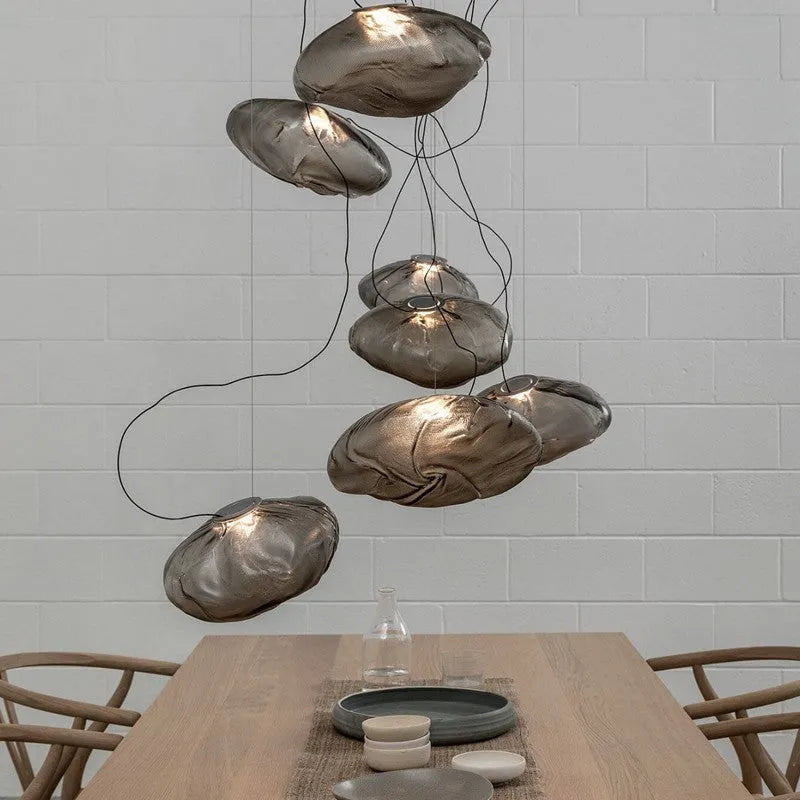 Modern light luxury glass chandelier in amber, clear, and smoke grey colours for lounge lighting.