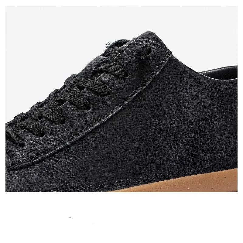 Men's black leather casual trainers with white rubber soles and laces on a white background.