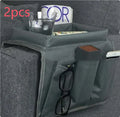 Black Oxford fabric sofa armrest organiser bag with 6 pockets on a couch handrail