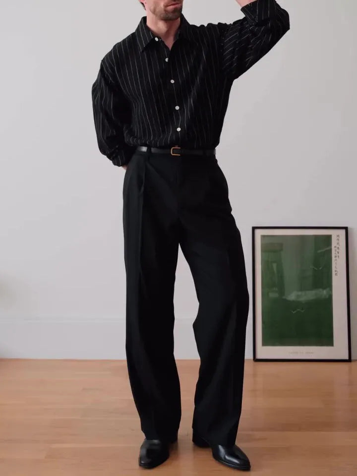 Men's black pinstriped button-down long sleeve shirt made from polyester fabric.