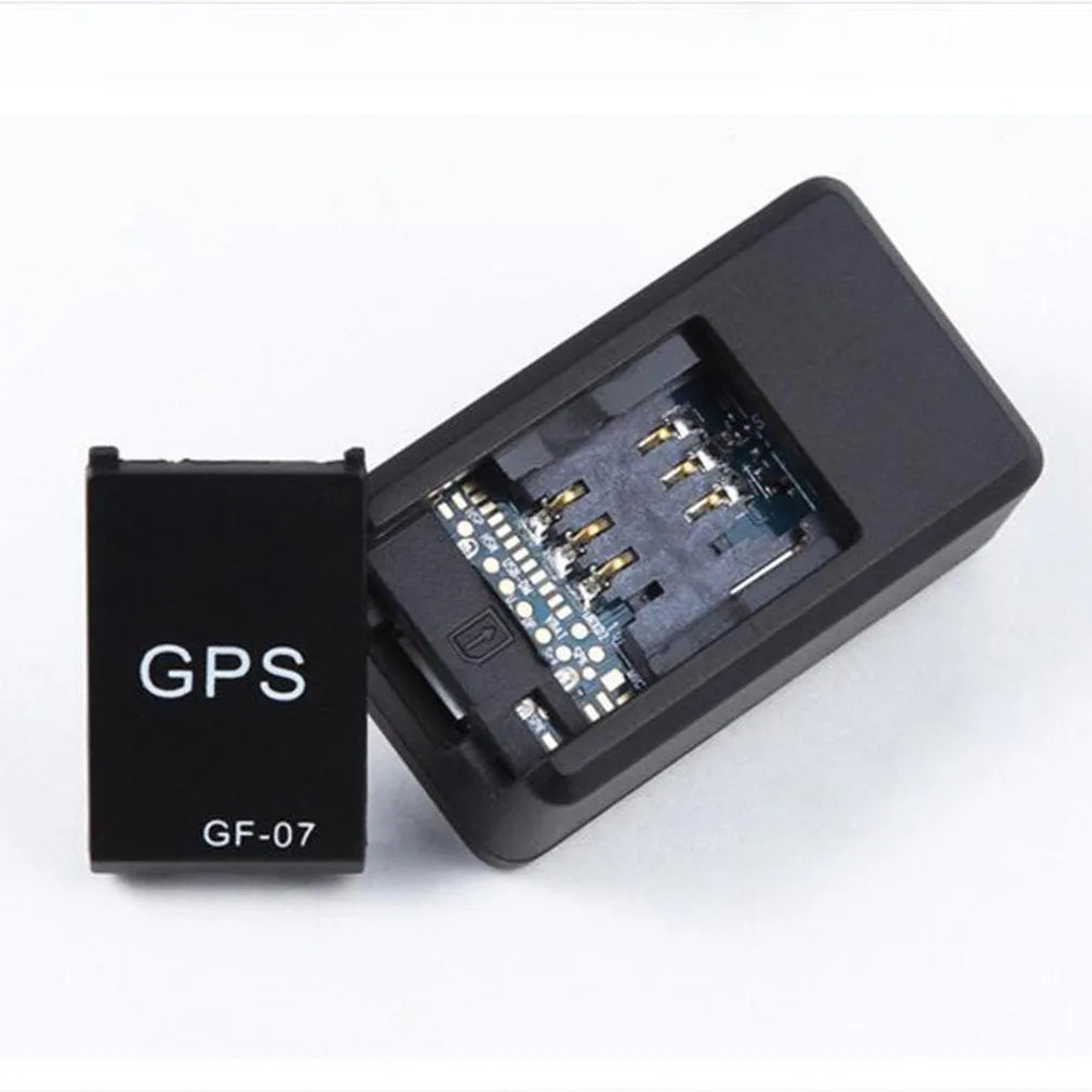Small black magnetic GPS tracker device with USB cable for real-time vehicle and asset tracking.