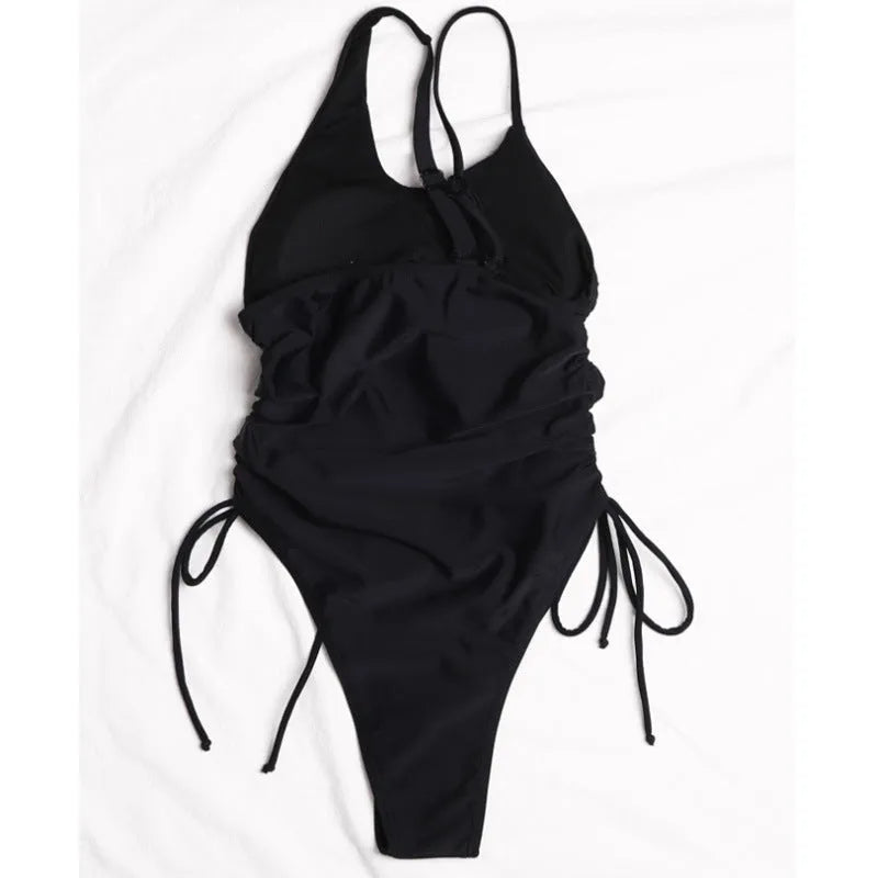 Black sleeveless women's dress with sloping shoulders and adjustable lacing detail