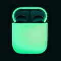 Glow-in-the-dark silicone flip-top protective case for Apple AirPods on a dark background.