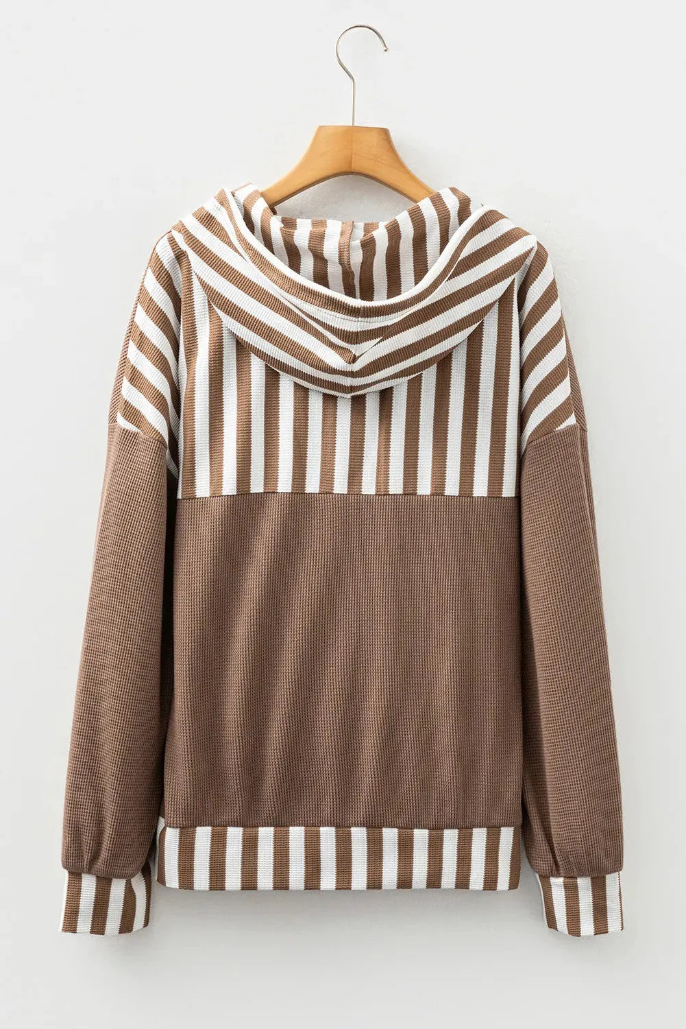Straw yellow striped hoodie with waffle texture patchwork, button neck, and drawstring hood laid flat.