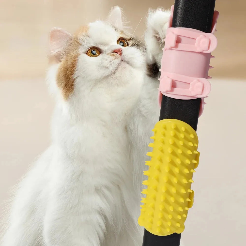 Silicone cat grooming comb with rounded teeth and adjustable strap mounted on a table leg.