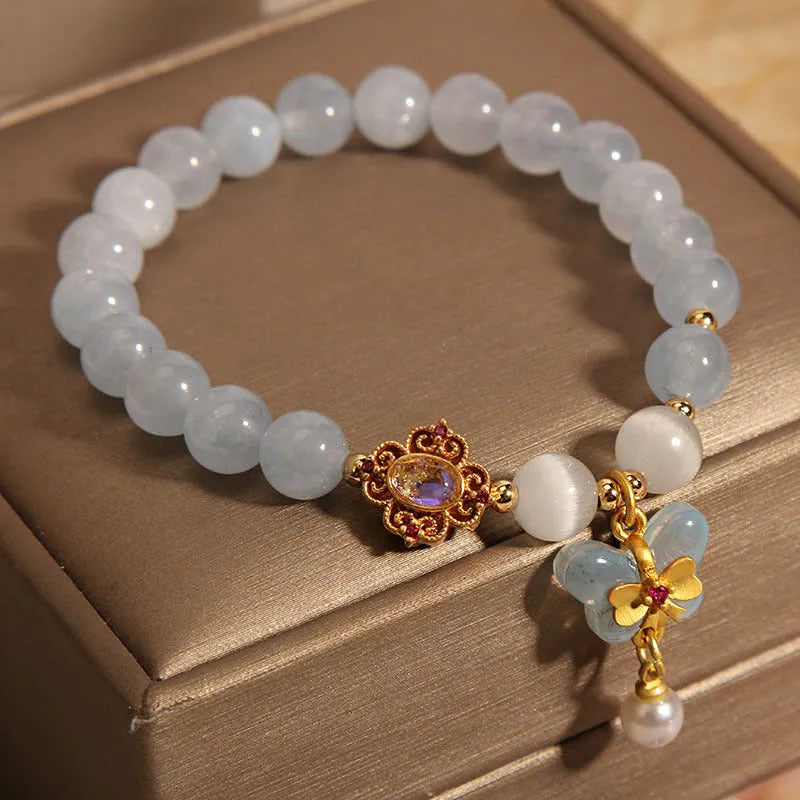 Women's aquamarine butterfly pendant crystal bracelet with rhinestone detailing on adjustable chain