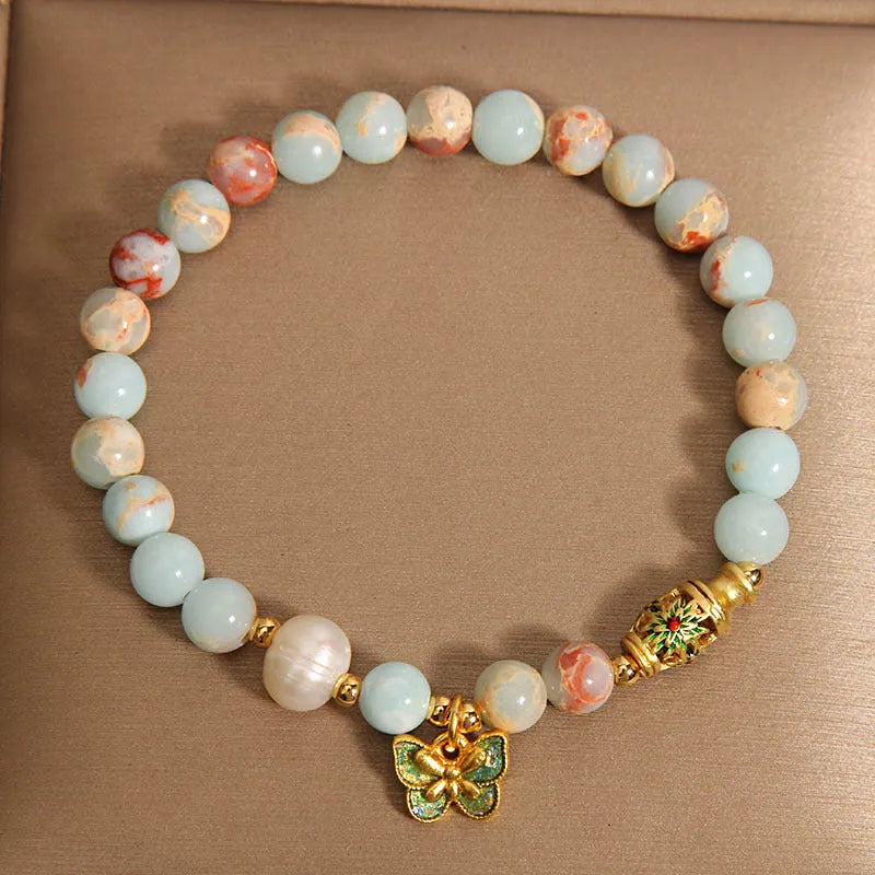 Blue freshwater pearl bracelet with Shoushan stone accents and detailed butterfly pendant