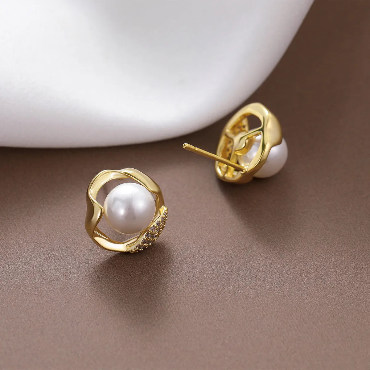 Beizhu zircon gold plated stud earrings in white colour on display