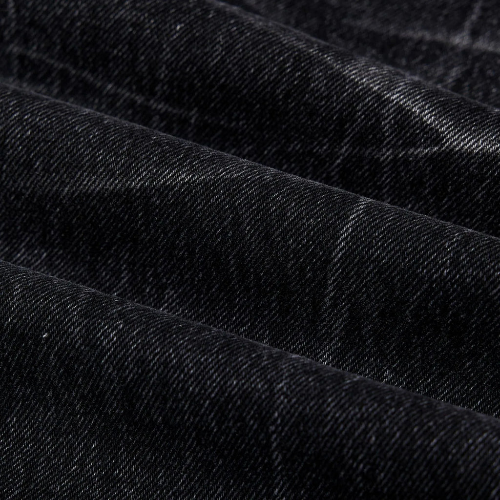 Men's black straight-leg jeans with a distressed lightning crack wash pattern on the legs.