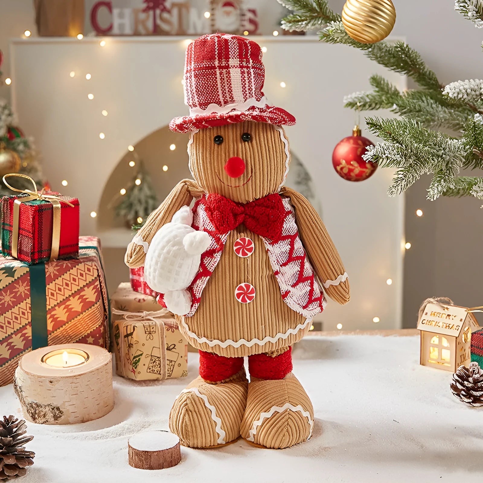 Gingerbread man cloth Christmas ornament with red and white hat, hanging on tree branch