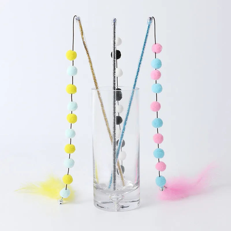 Cat toy teaser stick with plush ball and feathers, approximately 31 cm long, on a plain background.