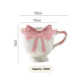 Ceramic mug with heart bow design in white powder and black pink colours.
