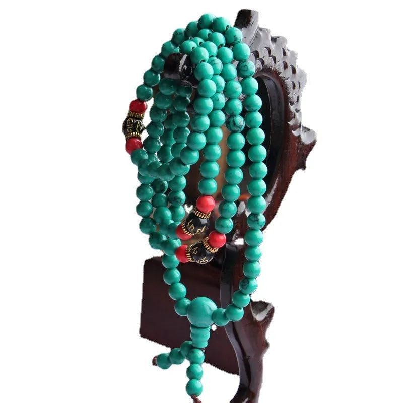 Turquoise Tibetan bracelet with 108 synthetic stone powder beads in round polished finish