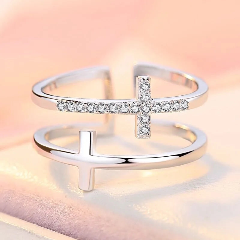 Double cross geometric women's ring with zircon stones on an adjustable copper band.