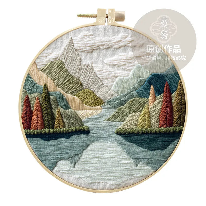 Embroidery DIY kit with landscape designs on cotton fabric, bamboo frame, thread, and needles