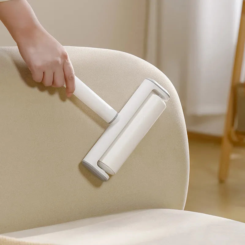 Refillable lint remover roller with tearable paper for pet hair removal on household surfaces