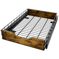 Black stackable kitchen storage rack with a pull-out woven basket drawer on a wood and iron frame.