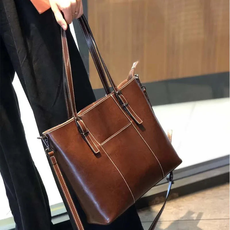 Brown genuine leather women's shoulder bag with retro styling and multiple organisational compartments