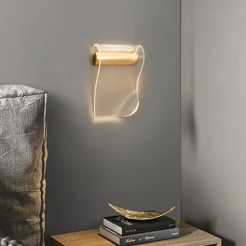 Modern wall lamp with acrylic shade and iron arm in a left bend design, mounted on a wall.