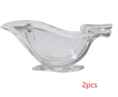 Transparent acrylic bird-shaped manual lemon juicer on a kitchen counter.