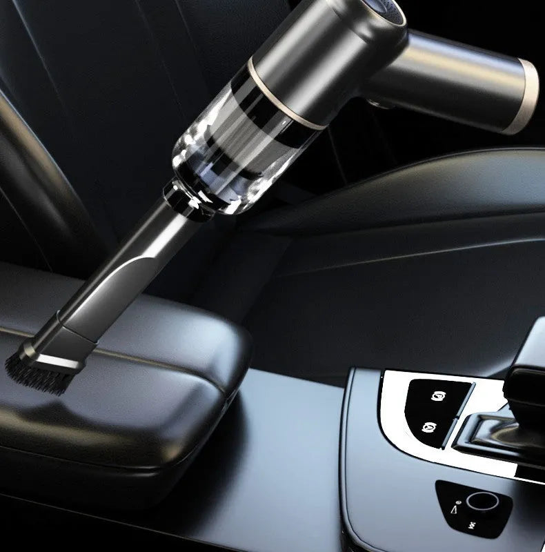 Black wireless car vacuum cleaner with multiple nozzle attachments and USB charging cable