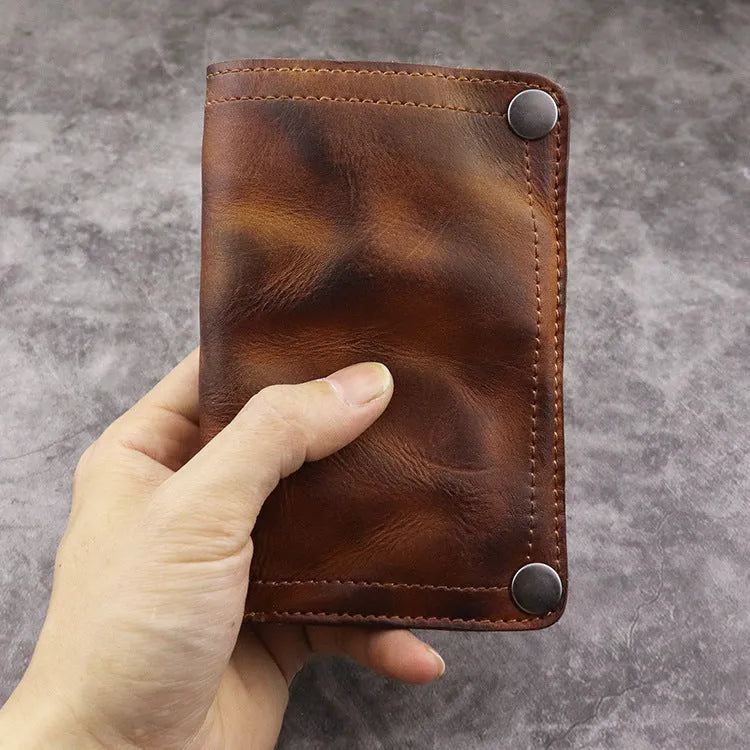 Men's retro-style long cowhide leather wallet open to show card slots, coin pocket, and bill compartment.