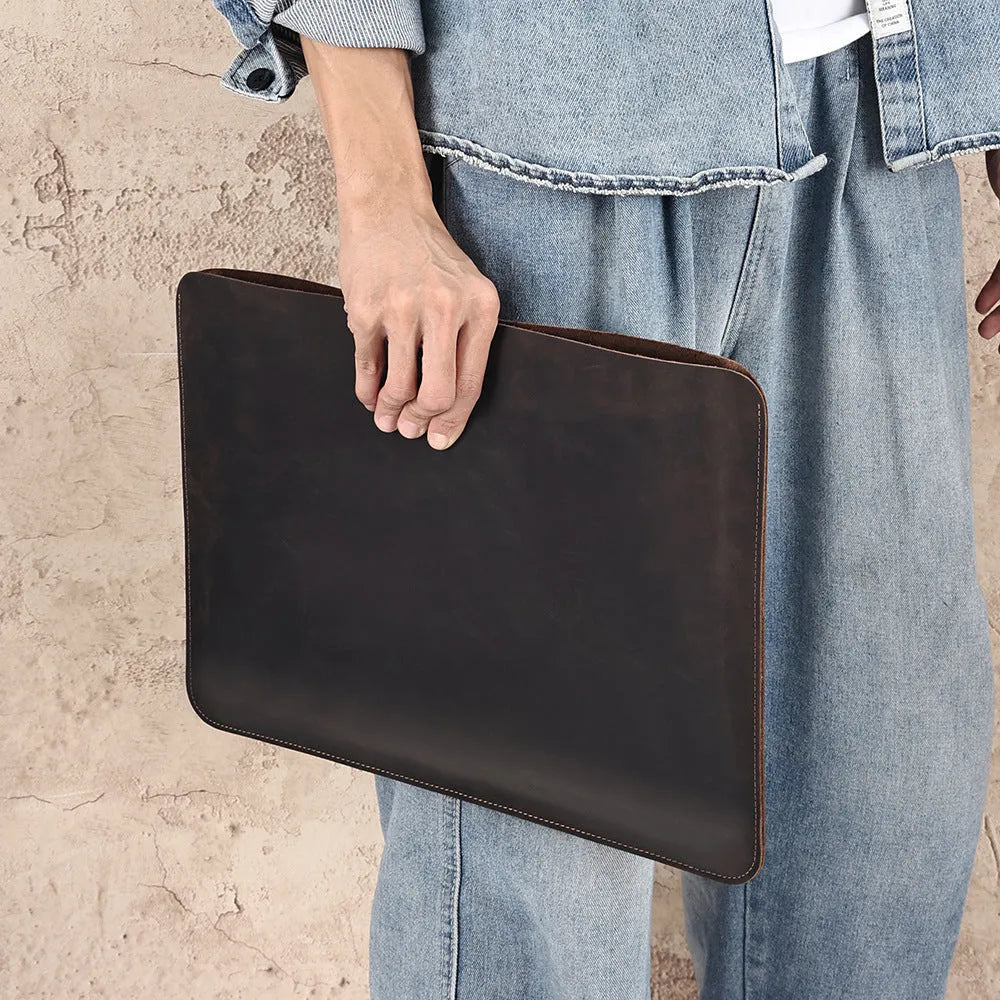 Brown genuine leather horizontal computer bag liner organiser with a laptop inside