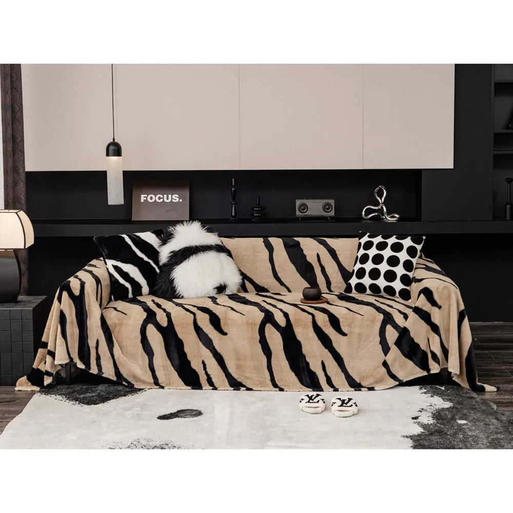 Zebra pattern flannel sofa cover in caramel colour on a sofa, showing non-slip fit and matching pillowcase.
