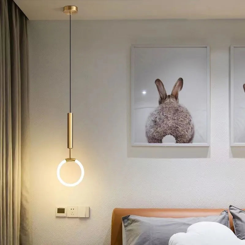 Modern Nordic style U-shaped white pendant light hanging above a wooden bedside table.