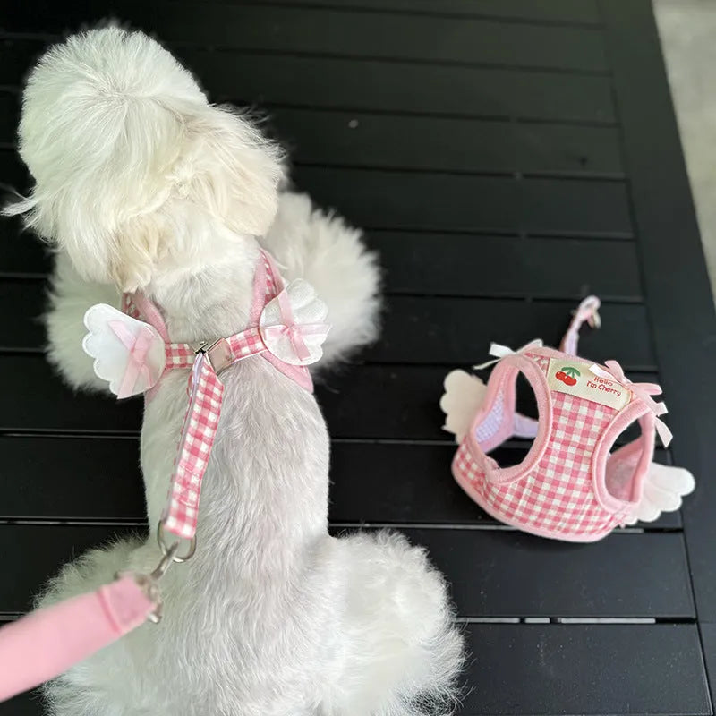 Pink cotton chest and back harness with hand-holding rope for a small dog on a white background.