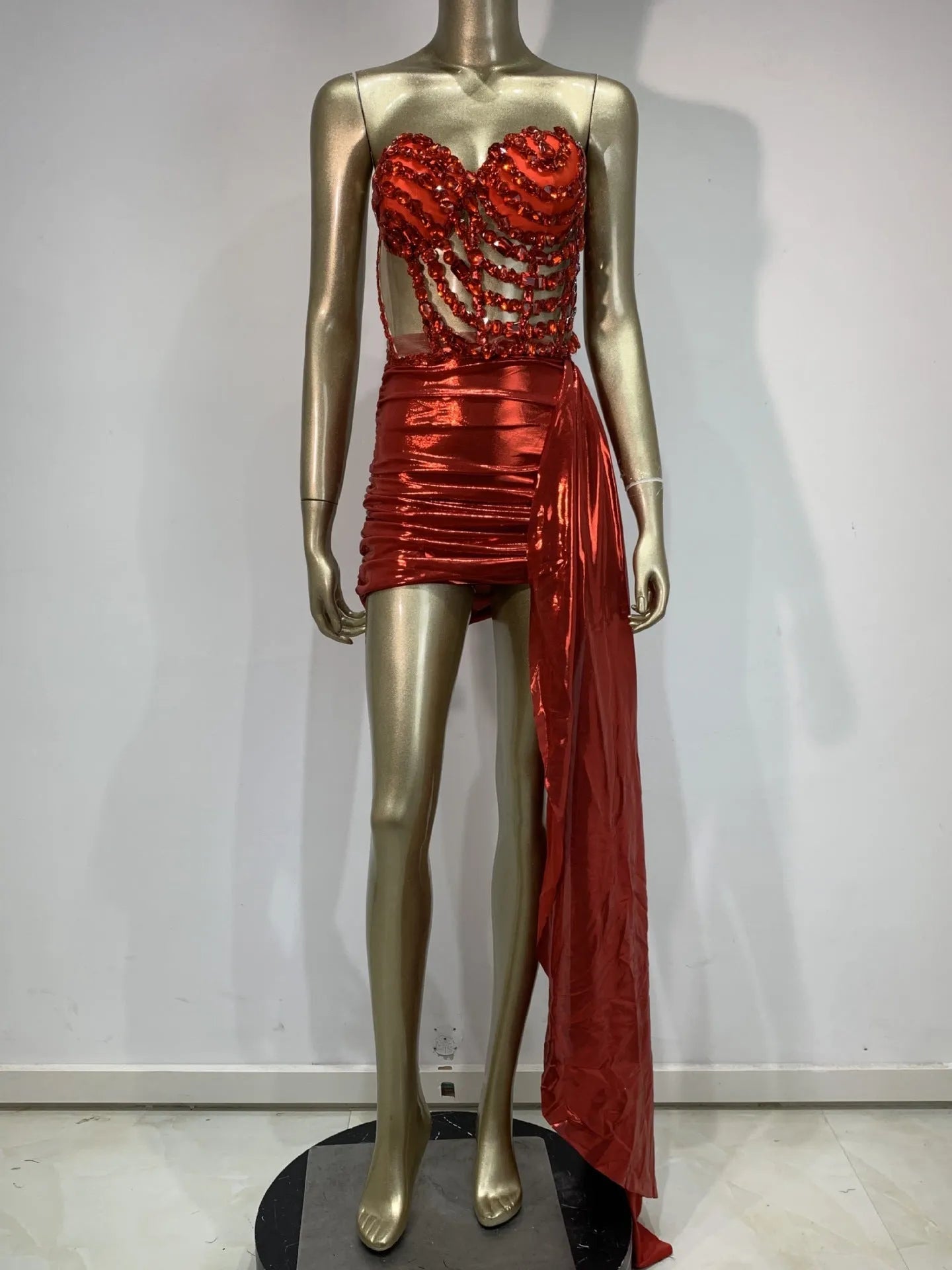Red two-piece stage costume with hollow mesh panels and a skirt, made from stretch spandex for performers.