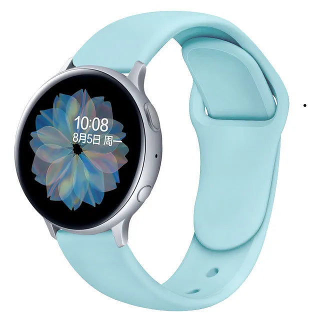 Samsung Galaxy Active 2 watch with a purple reverse buckle silicone strap on a wrist.
