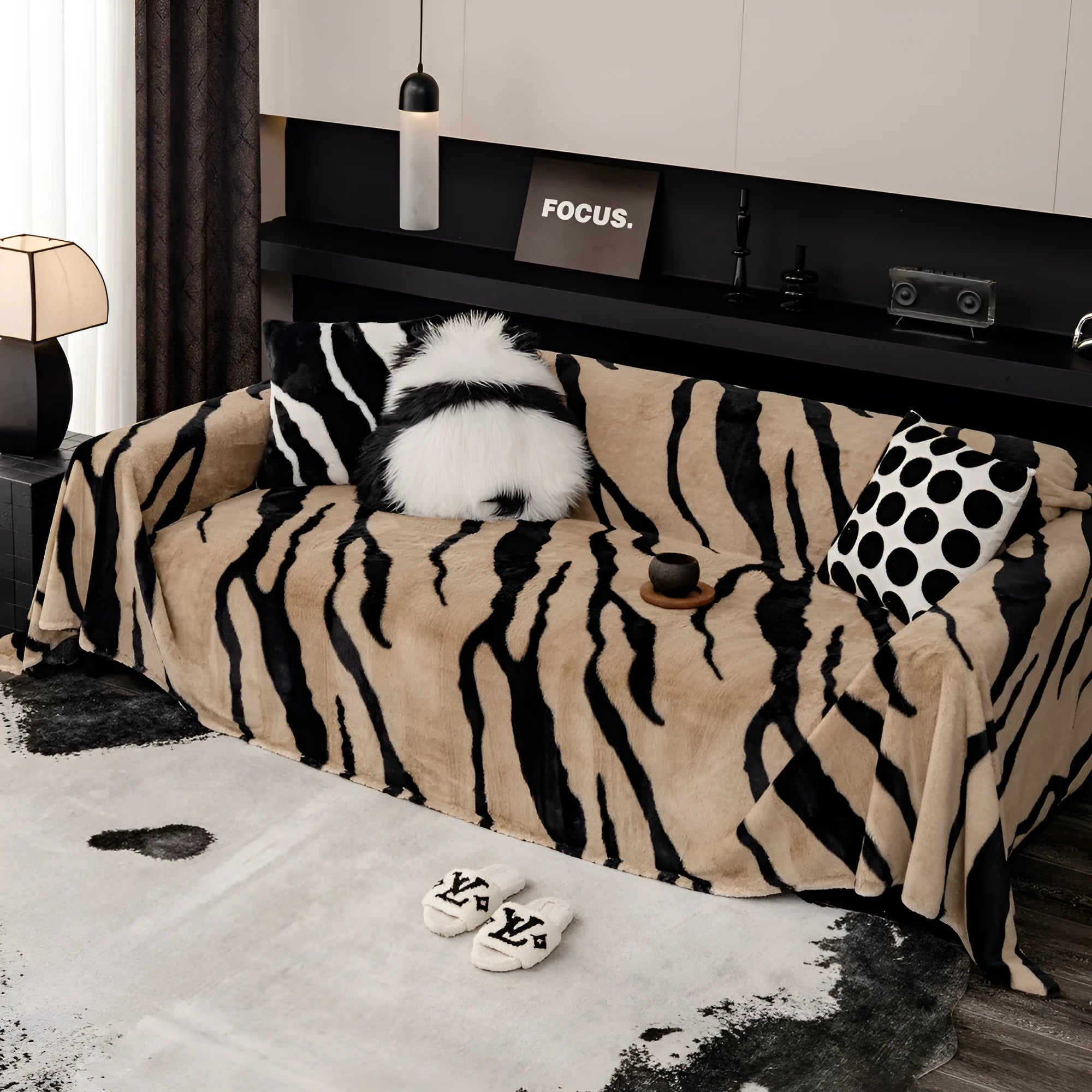 Zebra pattern flannel sofa cover in caramel colour on a sofa, showing non-slip fit and matching pillowcase.