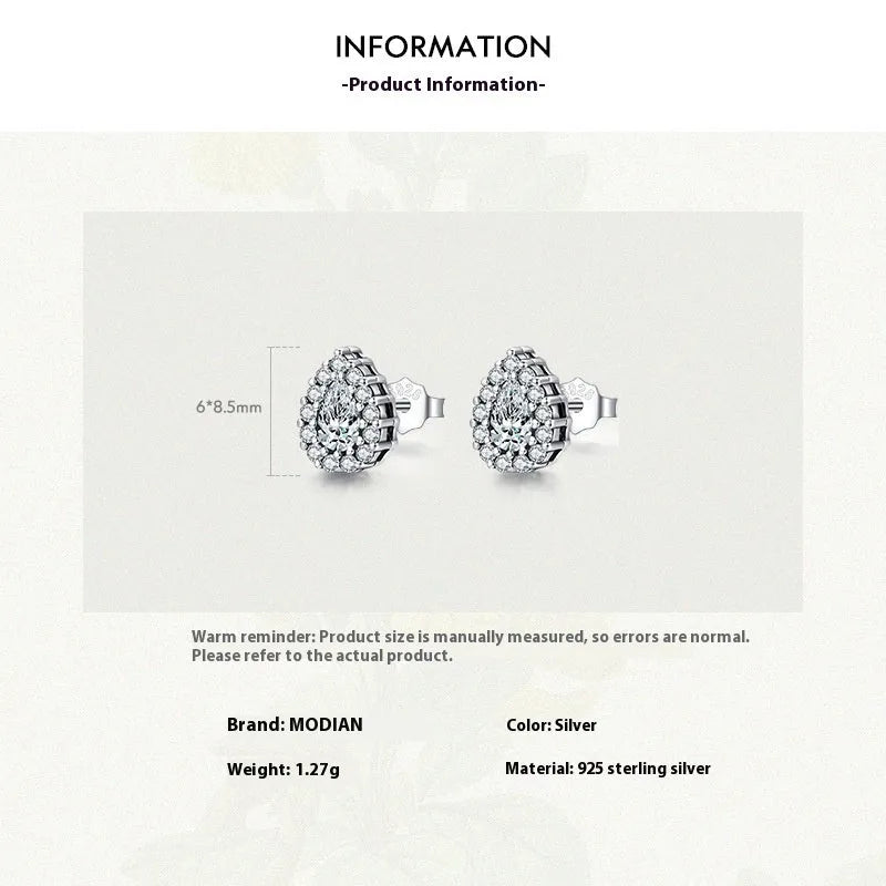 Close-up of a women's sterling silver drop ear stud with a polished finish and diamond-treated detail.
