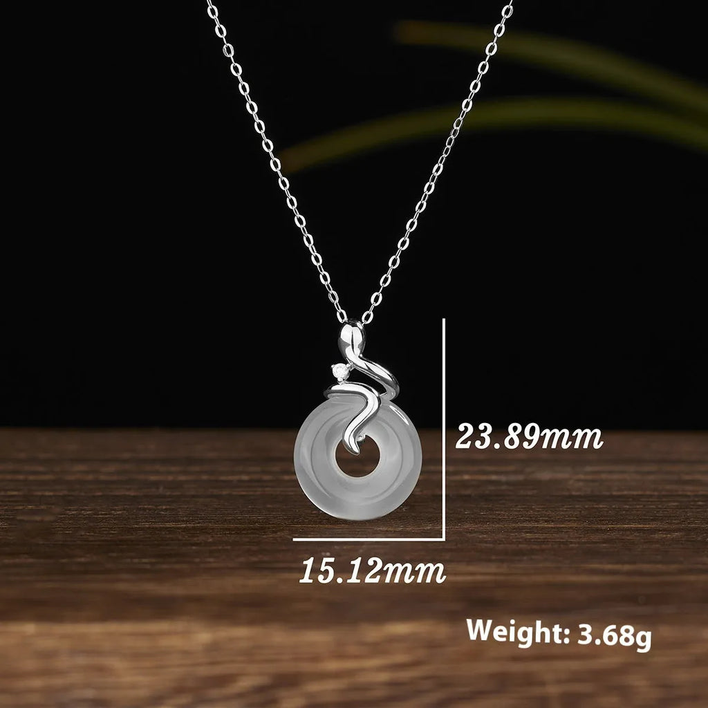 Women's sterling silver snake necklace with white jade inlay pendant on cross chain