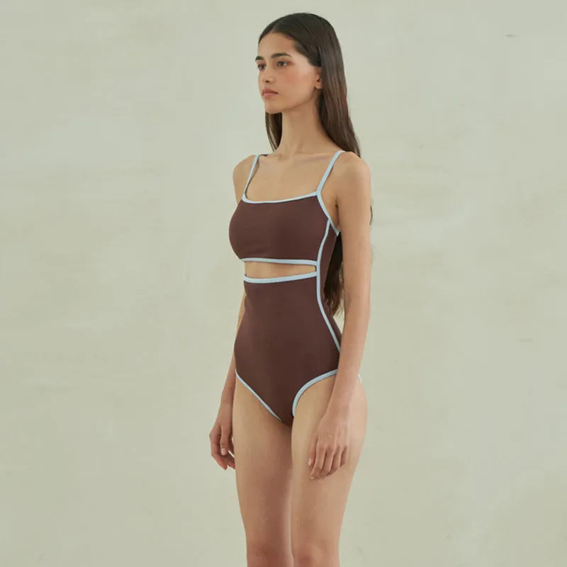 Brown women's triangle one-piece nylon swimsuit on a hanger.