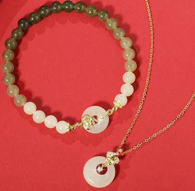 Peach blossom Hetian jade bracelet and necklace set with flower-shaped beads in sterling silver setting