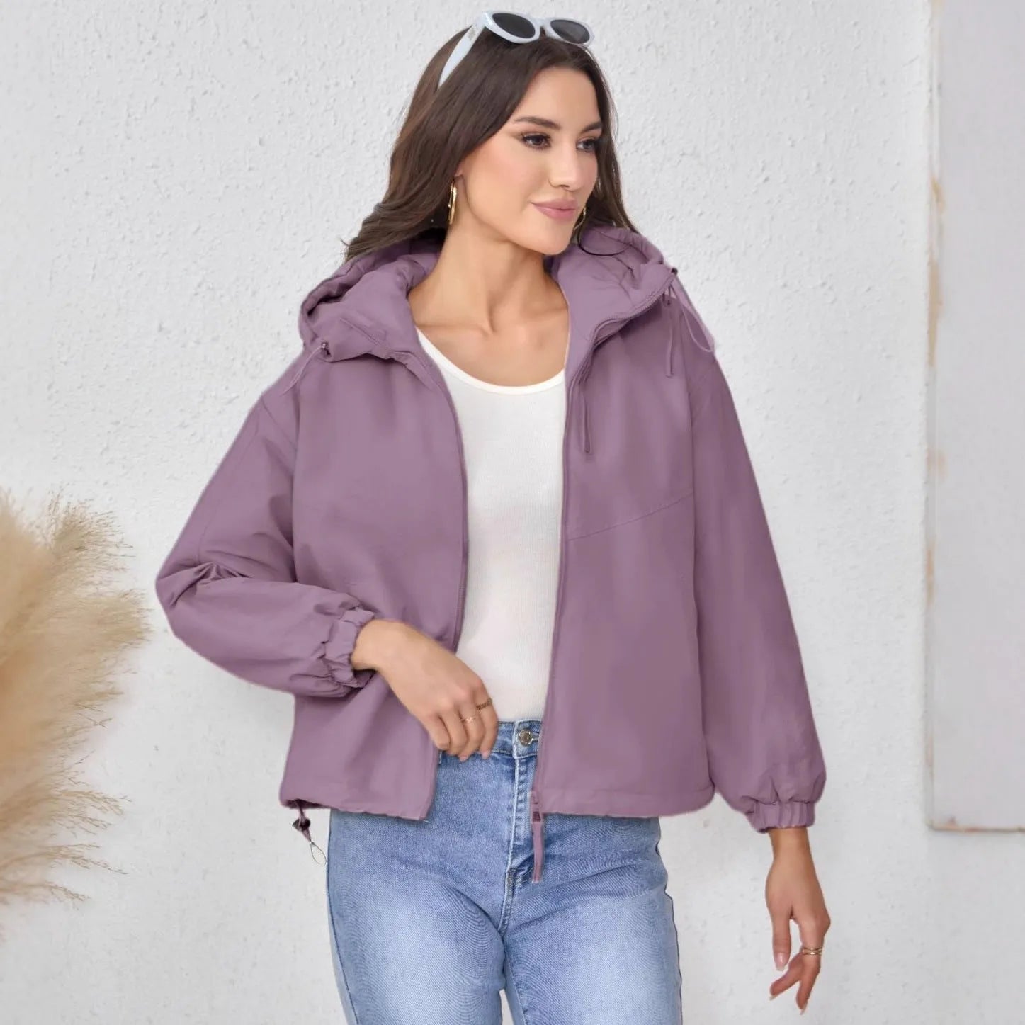 Women's grey loose-fit hooded polyester jacket with full zip and long sleeves.