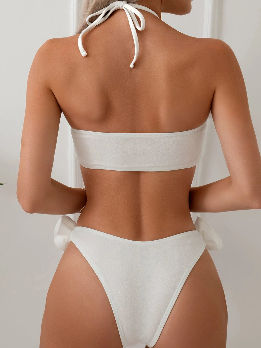 White halter neck lace-up swimsuit bikini with three-dimensional flower pattern.