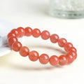 Natural cherry red agate beaded bracelet with high-polish stones on a wrist, showing single and three-strand style options.