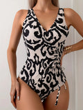 Backless one-piece women's swimsuit with mesh stitching detail in solid colour