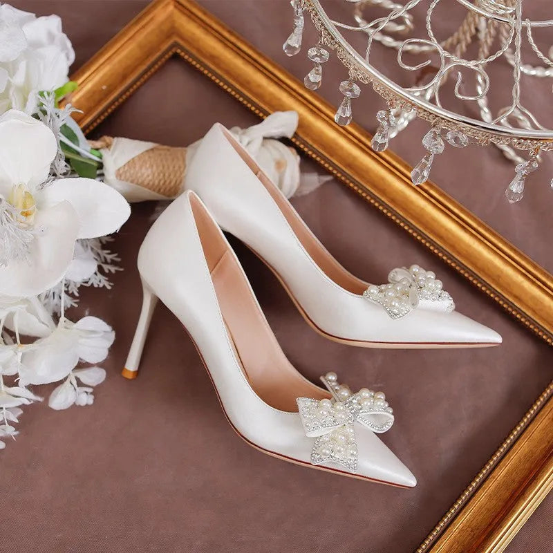 Women's stiletto heel bride wedding dress shoes in milky white with pointed toe and low top