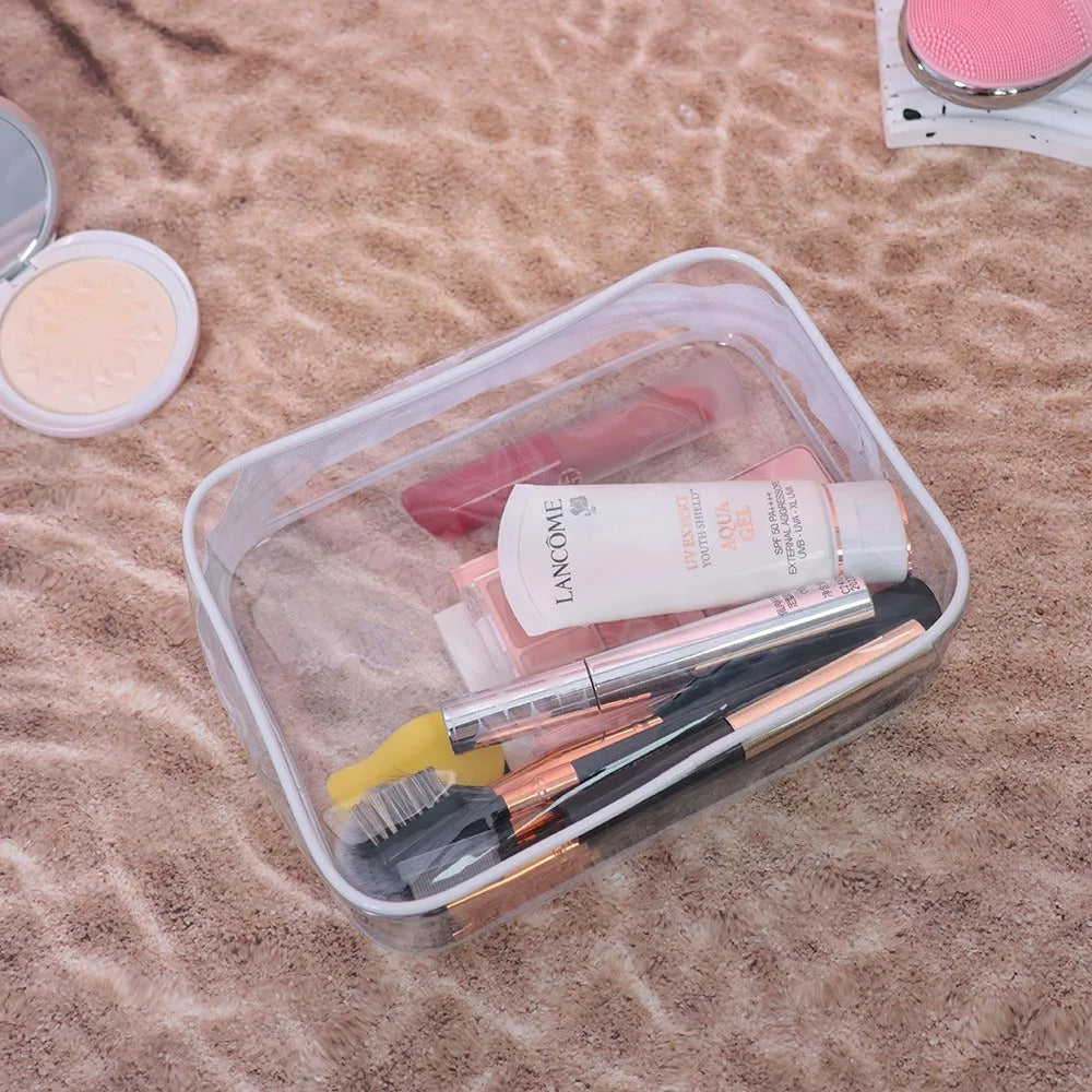 Semi-transparent PVC makeup bag in black, pink, or white colour, shown in L and XL sizes.