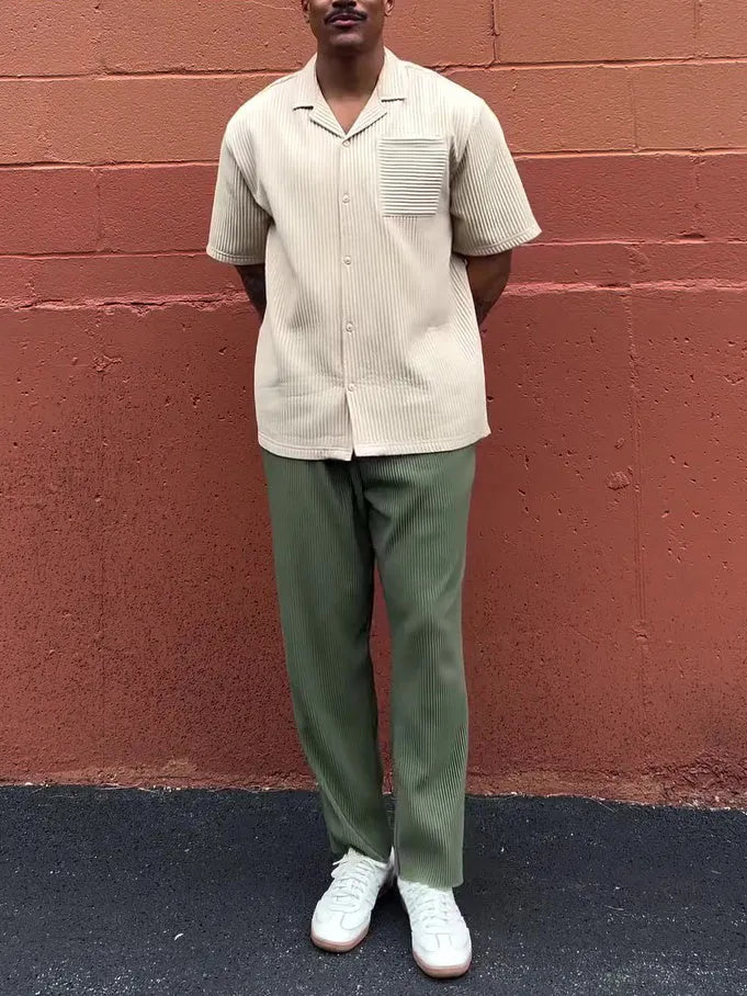 Green men's pleated casual trousers showing ankle-length cut and regular fit