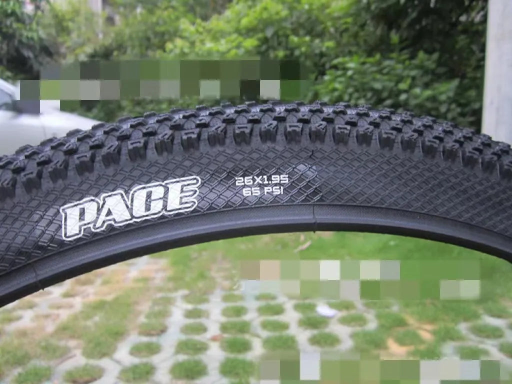 Ultralight mountain bike tyre with black tread and optional white sidewall, shown in sizes 26, 27.5 and 29 inch.