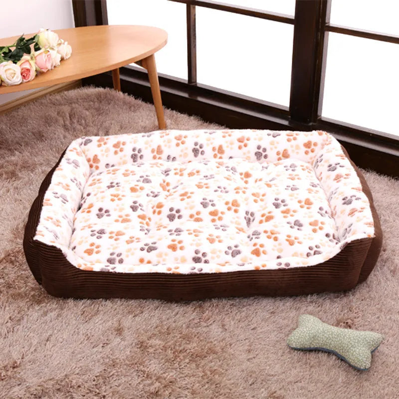 Beige sofa-style plush pet bed for small dogs with raised basket edges on a wooden floor.